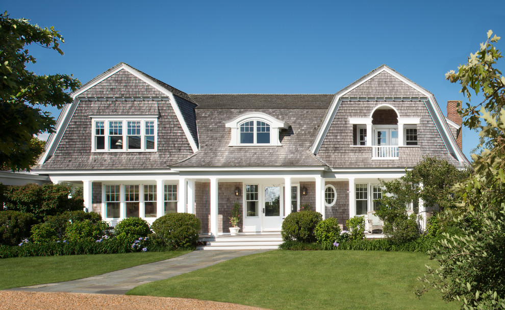 Photo of a beach style two-storey exterior in DC Metro with wood siding and a gambrel roof.
