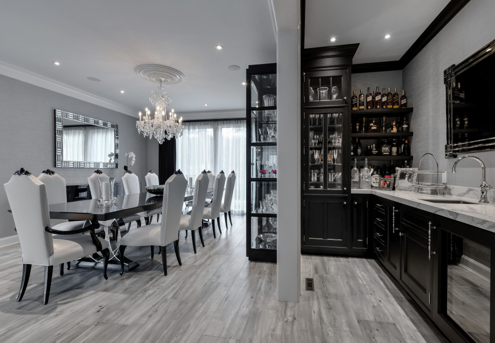 Inspiration for a mid-sized transitional l-shaped wet bar in New York with an integrated sink, recessed-panel cabinets, dark wood cabinets, quartz benchtops, grey splashback, porcelain floors, grey floor and white benchtop.
