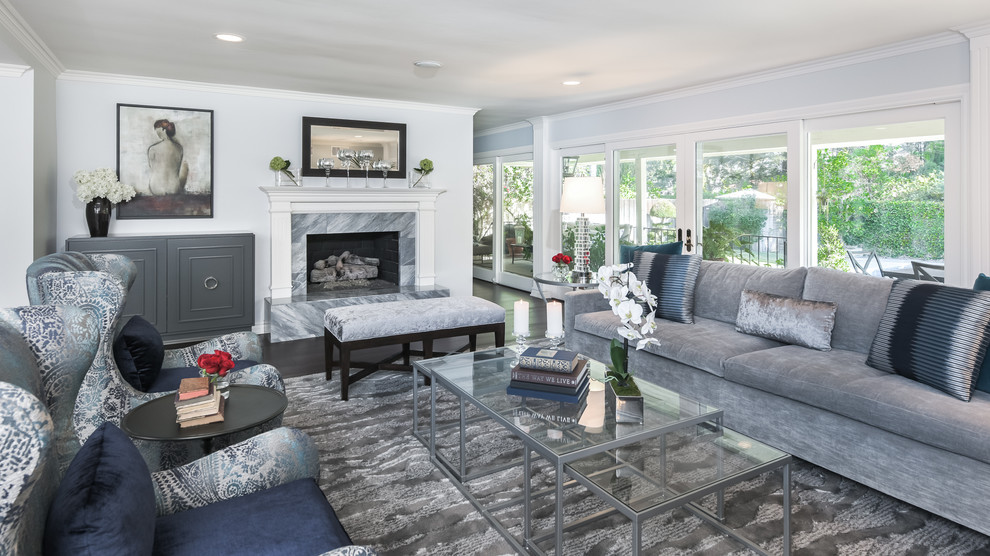 Design ideas for a large transitional open concept living room in Los Angeles with grey walls, dark hardwood floors, a standard fireplace, a stone fireplace surround and brown floor.