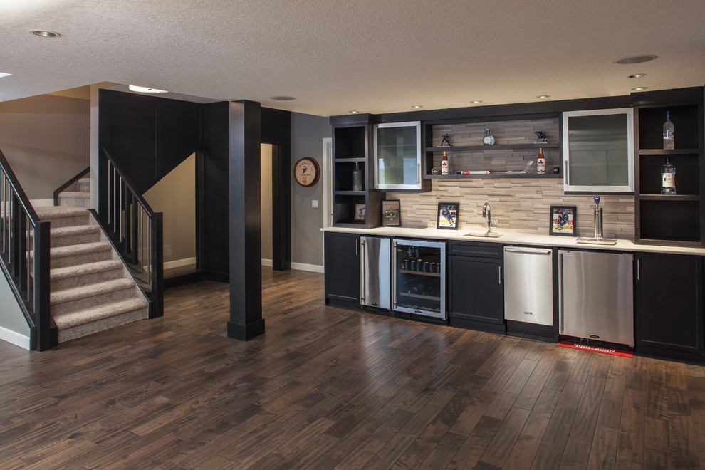 Design ideas for a mid-sized contemporary single-wall wet bar in Calgary with an undermount sink, shaker cabinets, black cabinets, quartzite benchtops, multi-coloured splashback, matchstick tile splashback, dark hardwood floors and brown floor.