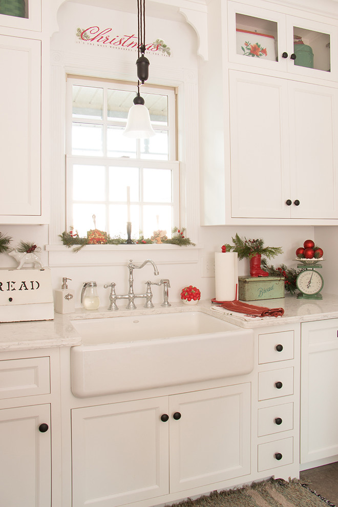 Design ideas for a small country galley kitchen in Other with a farmhouse sink, white cabinets, brick floors, shaker cabinets and marble benchtops.