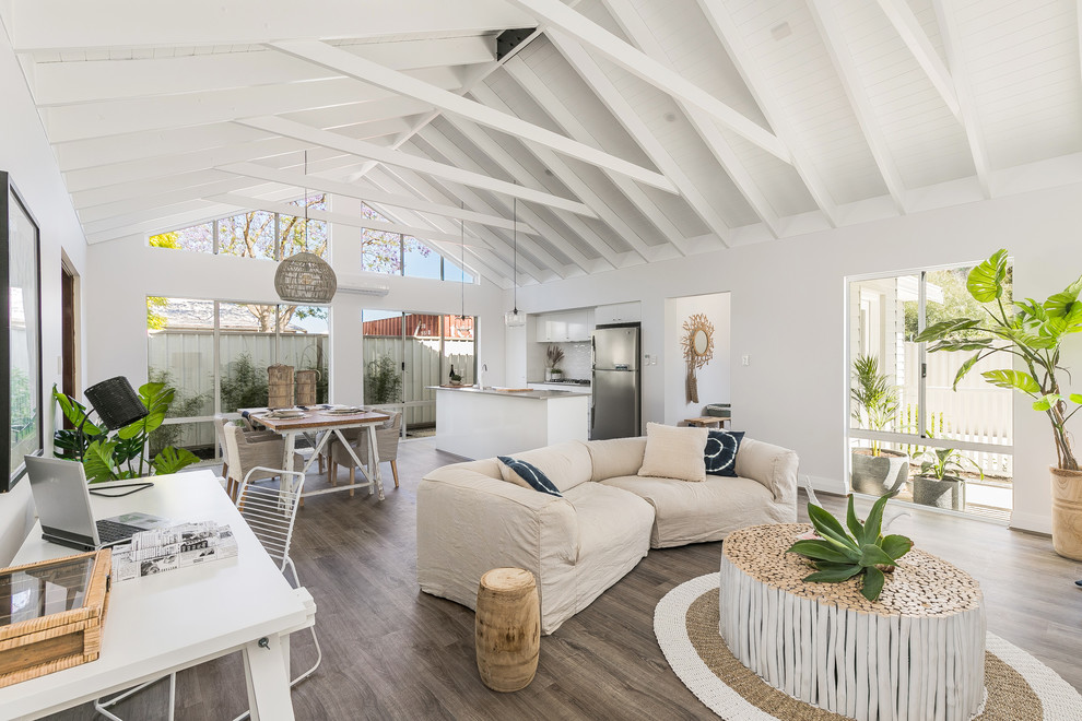 Inspiration for a beach style open concept living room in Perth with white walls, medium hardwood floors and brown floor.