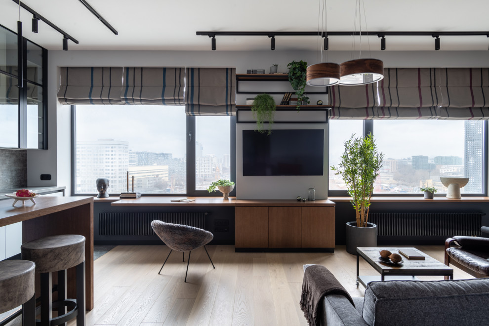 Источник вдохновения для домашнего уюта: гостиная комната среднего размера в современном стиле с телевизором на стене и зоной отдыха