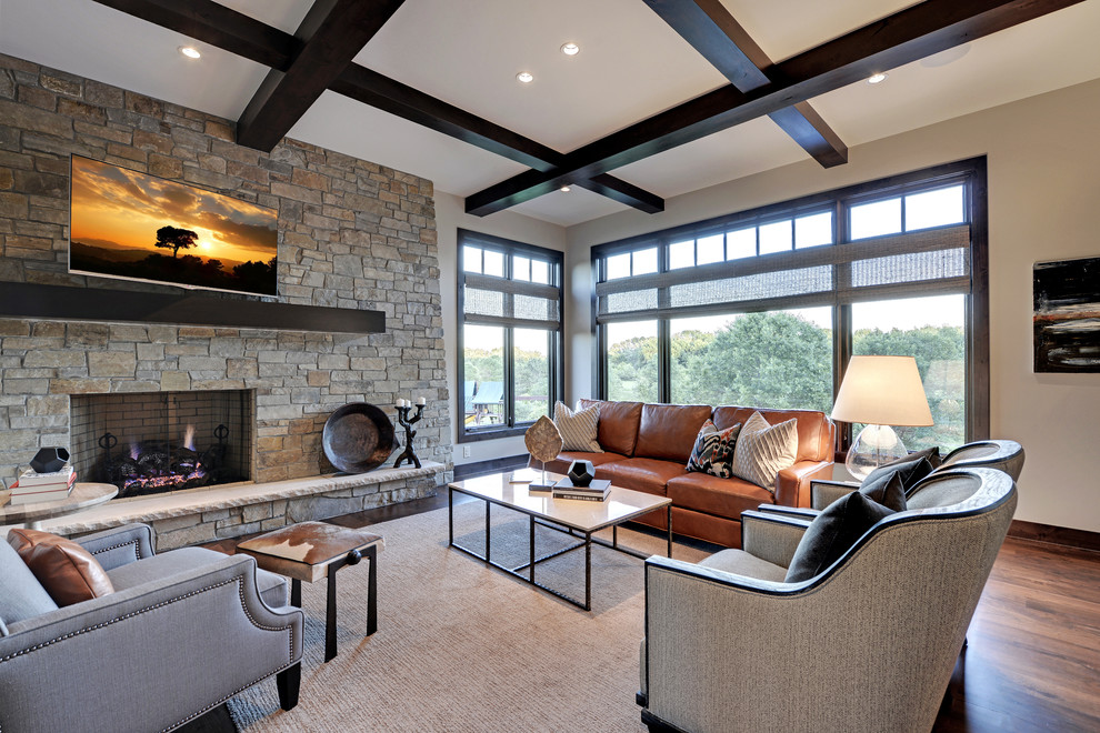 Large transitional living room in Minneapolis with a standard fireplace, a stone fireplace surround and a wall-mounted tv.