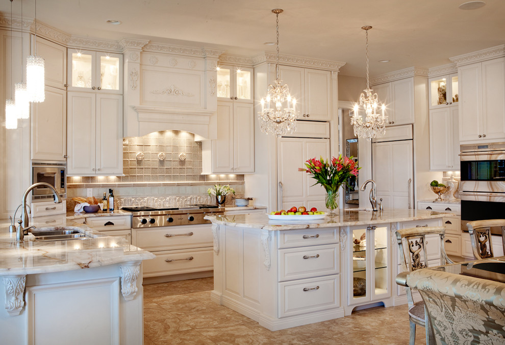 Inspiration for a large traditional u-shaped eat-in kitchen in St Louis with a triple-bowl sink, raised-panel cabinets, white cabinets, granite benchtops, beige splashback, panelled appliances, stone tile splashback, travertine floors and with island.