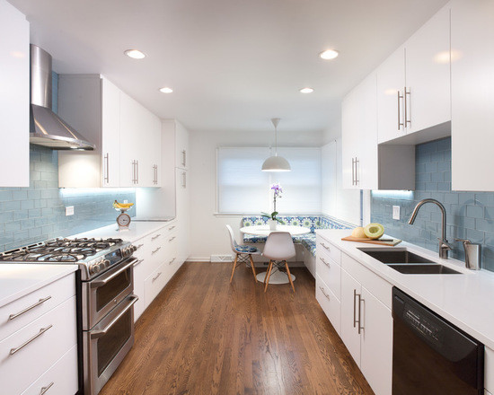 Photo of a mid-sized modern galley eat-in kitchen in Chicago with an undermount sink, flat-panel cabinets, white cabinets, copper benchtops, blue splashback, subway tile splashback, stainless steel appliances, medium hardwood floors and no island.
