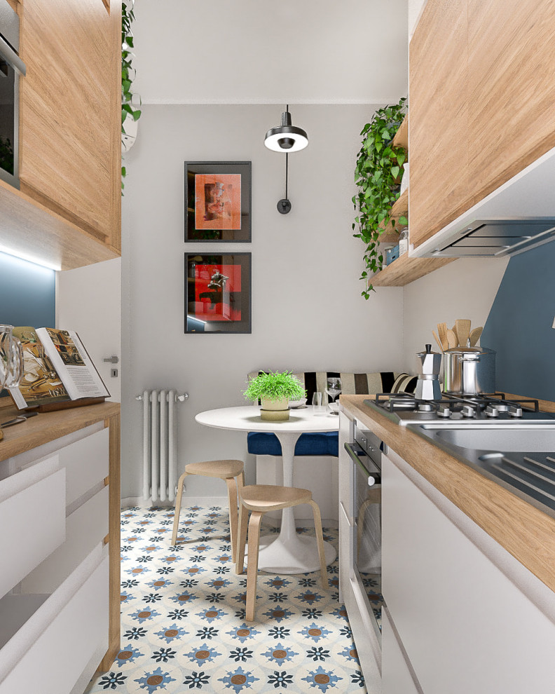 Inspiration for a small contemporary galley separate kitchen in Milan with a single-bowl sink, flat-panel cabinets, white cabinets, wood benchtops, blue splashback, stainless steel appliances, porcelain floors, a peninsula, multi-coloured floor and recessed.