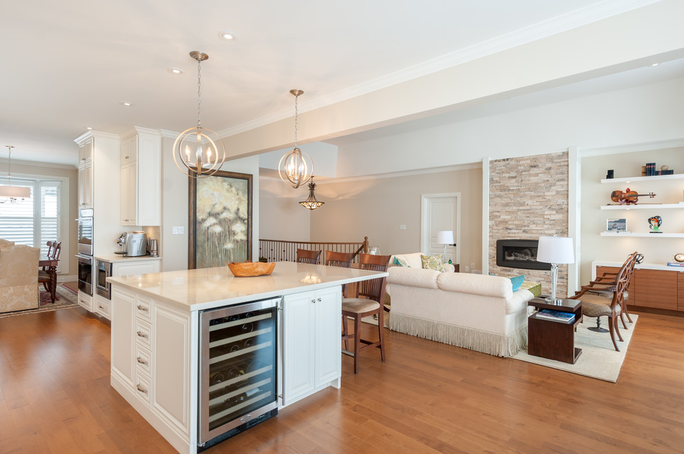 Design ideas for a mid-sized traditional single-wall eat-in kitchen with an undermount sink, beaded inset cabinets, white cabinets, granite benchtops, beige splashback, stainless steel appliances, medium hardwood floors and with island.