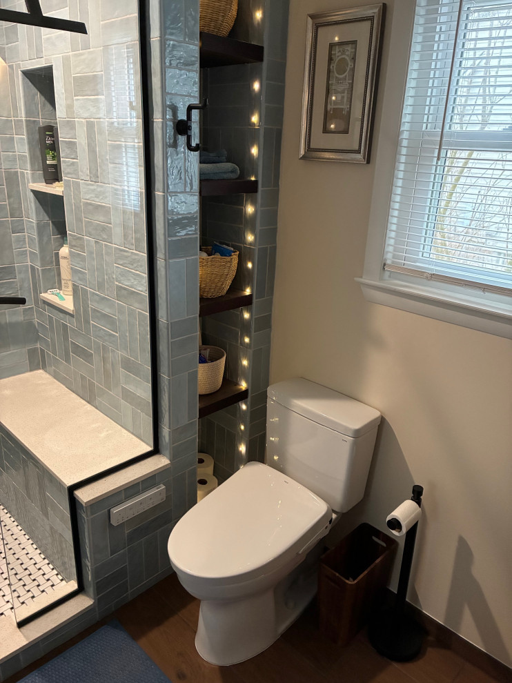 Mid-sized 1960s master blue tile and ceramic tile porcelain tile, brown floor and double-sink shower bench photo with shaker cabinets, blue cabinets, a bidet, beige walls, a vessel sink, a hinged shower door, white countertops and a floating vanity