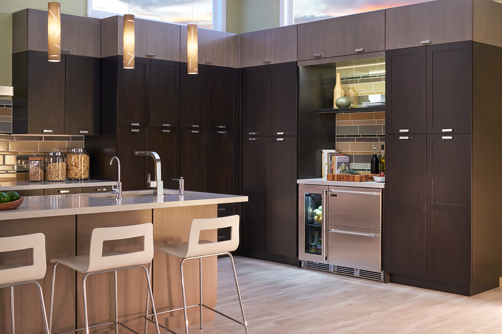 Contemporary kitchen in Chicago with an undermount sink, shaker cabinets, dark wood cabinets, brown splashback, matchstick tile splashback, stainless steel appliances, light hardwood floors and with island.