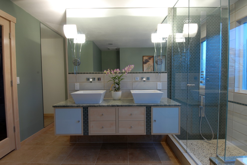 Inspiration for a contemporary bathroom in Denver with a vessel sink, flat-panel cabinets, light wood cabinets, granite benchtops, a drop-in tub, a corner shower, green tile and glass tile.