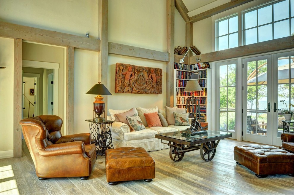 Inspiration for a large country open concept living room in Burlington with beige walls, light hardwood floors and a library.