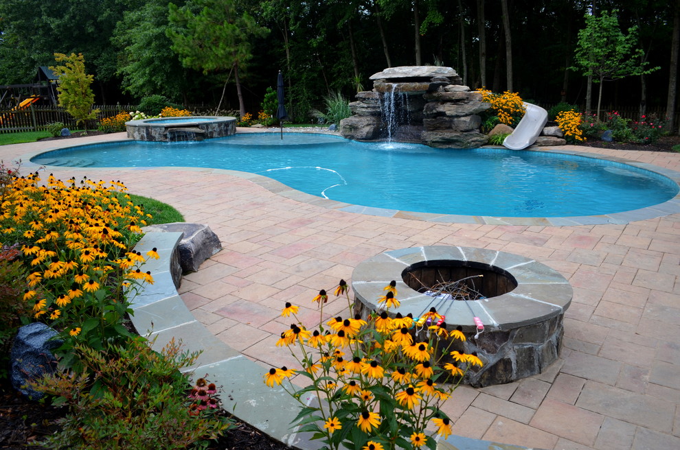 Inspiration for a huge transitional backyard concrete paver and custom-shaped natural pool fountain remodel in DC Metro