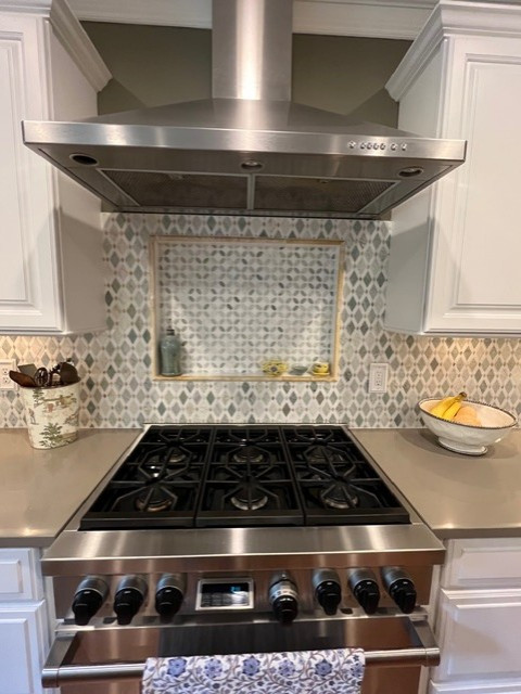Inspiration for a large transitional u-shaped eat-in kitchen remodel with raised-panel cabinets, white cabinets, quartz countertops, green backsplash, mosaic tile backsplash, stainless steel appliances, an island and green countertops