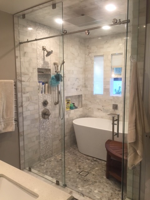 Inspiration for a mid-sized contemporary master bathroom in San Francisco with raised-panel cabinets, white cabinets, a claw-foot tub, an alcove shower, a one-piece toilet, white tile, matchstick tile, white walls, light hardwood floors, an integrated sink and granite benchtops.