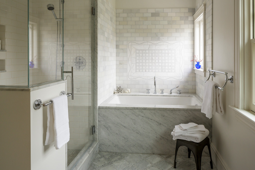 Mid-sized transitional bathroom in Providence with flat-panel cabinets, white cabinets, an undermount tub, a corner shower, stone tile, white walls, an undermount sink, marble benchtops and white tile.
