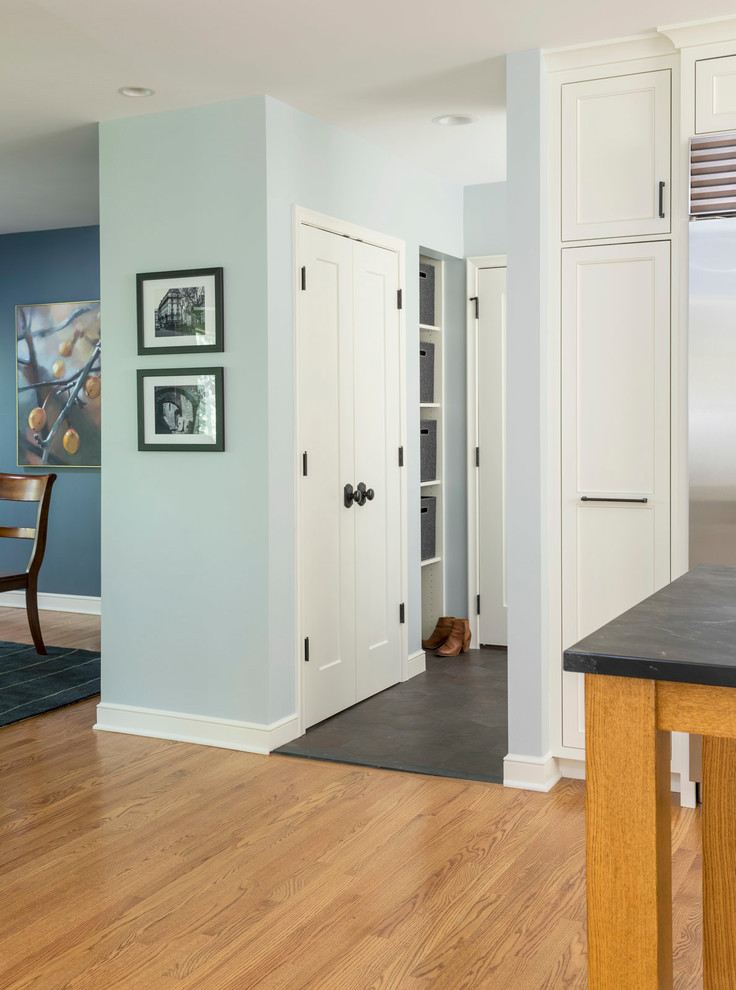 Mid-sized transitional medium tone wood floor and brown floor hallway photo in Minneapolis with gray walls