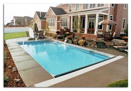 Backyard stone and rectangular pool photo
