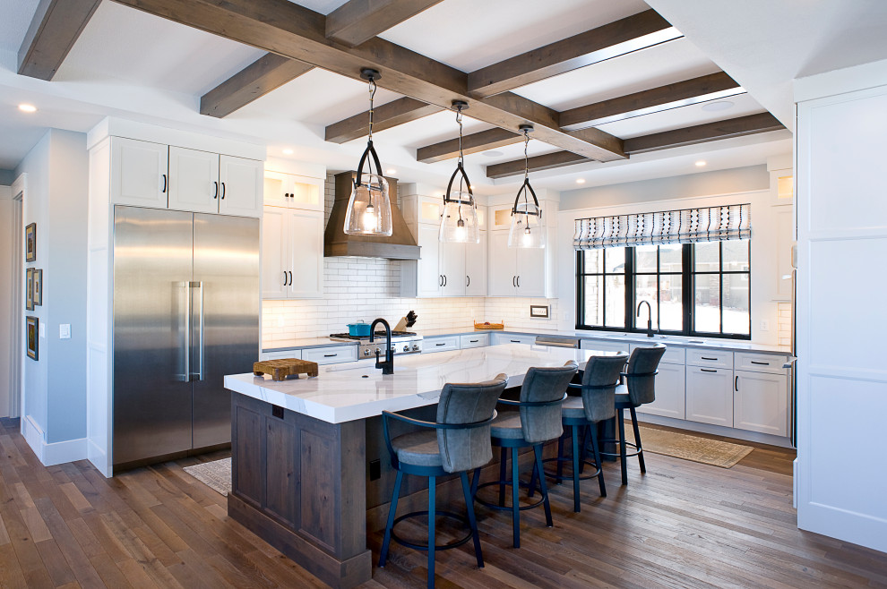 Eat-in kitchen - large farmhouse u-shaped eat-in kitchen idea with flat-panel cabinets, white cabinets, white backsplash, an island and white countertops