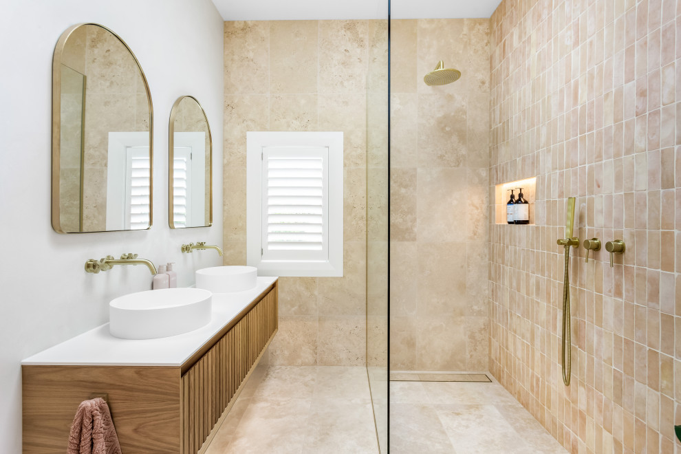 Inspiration for a large traditional ensuite bathroom in Auckland with beaded cabinets, medium wood cabinets, a double shower, a two-piece toilet, orange tiles, terracotta tiles, orange walls, terracotta flooring, a trough sink, soapstone worktops, an open shower, white worktops, a wall niche, double sinks and a floating vanity unit.