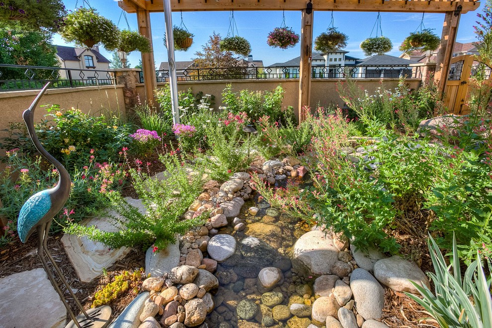 Photo of a mid-sized transitional partial sun front yard stone walkway in Denver.