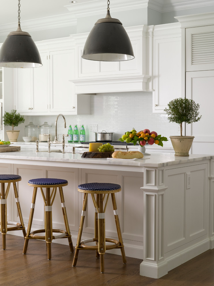 Traditional kitchen in New York with recessed-panel cabinets, white cabinets and with island.