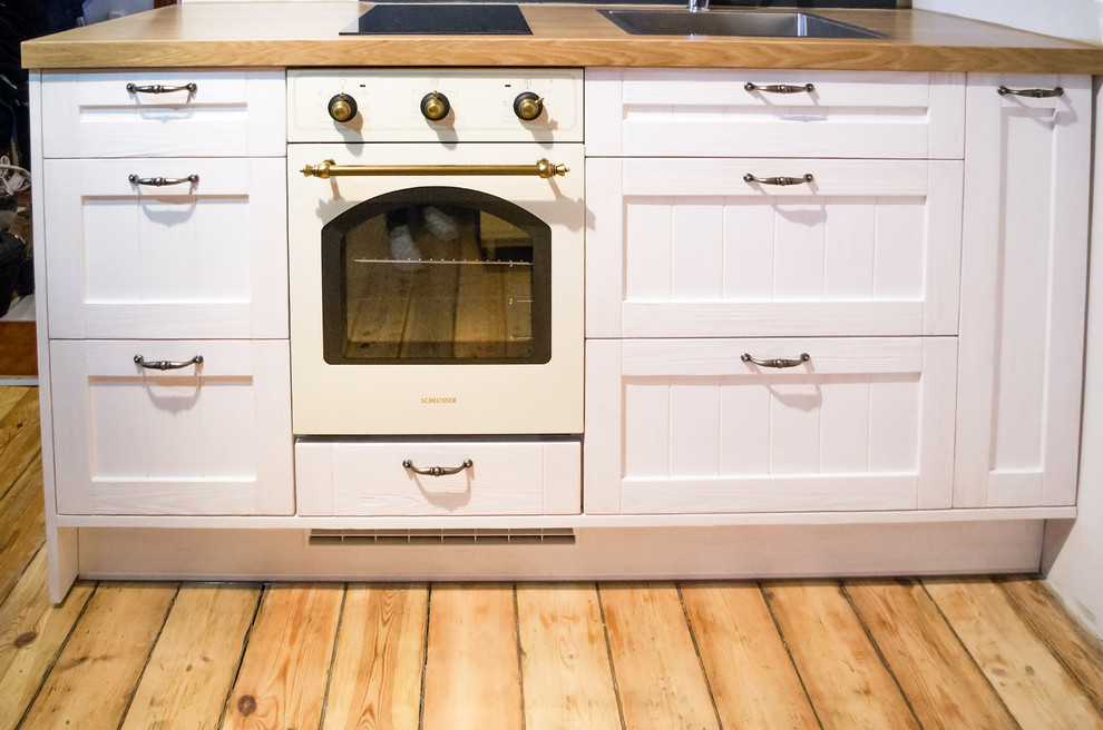 Inspiration for a small rustic single-wall kitchen remodel with recessed-panel cabinets