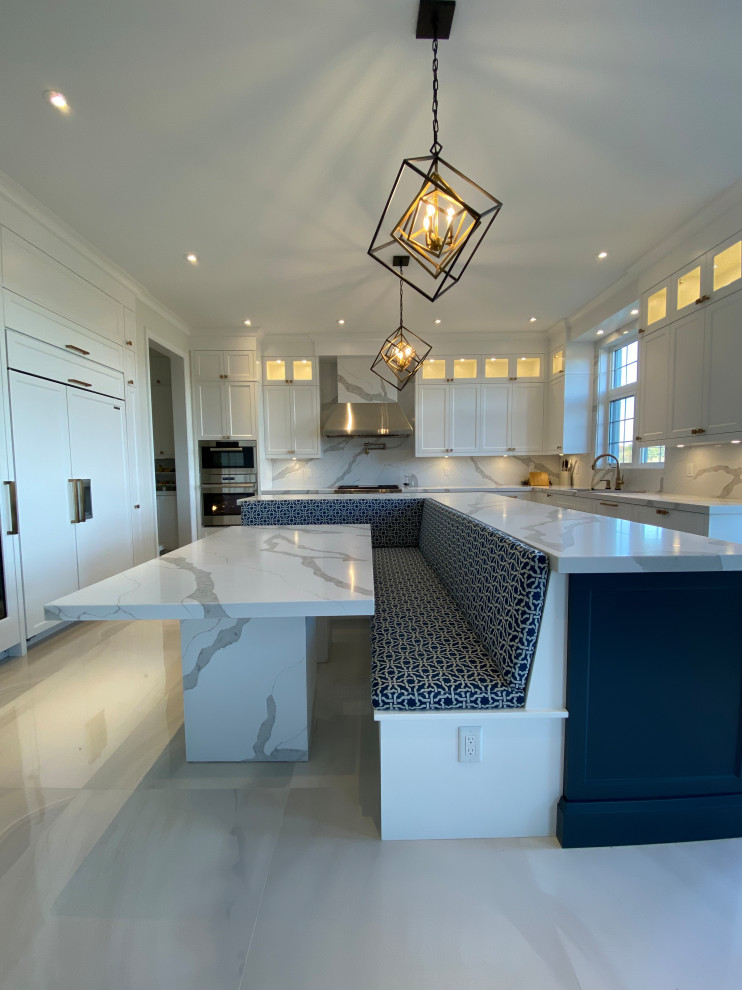This is an example of an expansive midcentury l-shaped eat-in kitchen in Toronto with flat-panel cabinets, white cabinets, quartz benchtops, marble floors, with island, grey floor and grey benchtop.