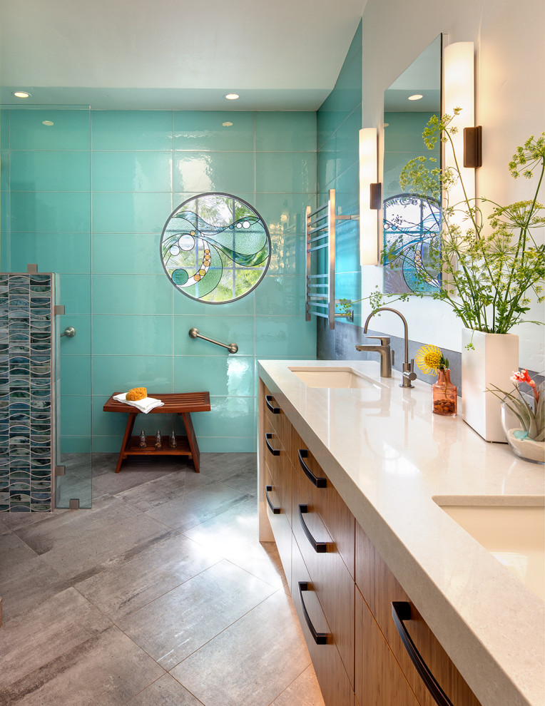 Design ideas for a mid-sized contemporary bathroom in San Diego with flat-panel cabinets, medium wood cabinets, a curbless shower, blue tile, white walls, an undermount sink, grey floor, an open shower, white benchtops, a shower seat, a double vanity and a built-in vanity.