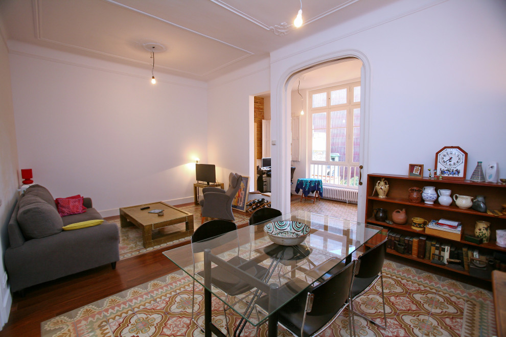 Foto de sala de estar abierta ecléctica de tamaño medio con paredes blancas, suelo de baldosas de cerámica, televisor en una esquina, suelo marrón, casetón y ladrillo