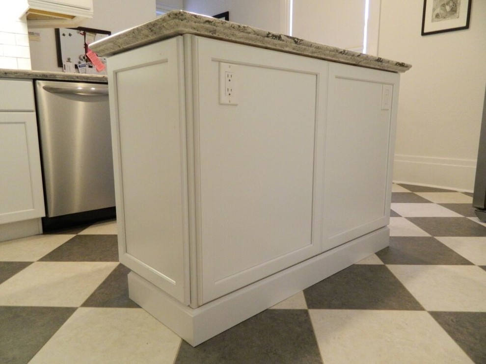 Transitional enclosed kitchen photo in Toronto with an undermount sink, recessed-panel cabinets, quartz countertops, white backsplash, ceramic backsplash, stainless steel appliances and an island