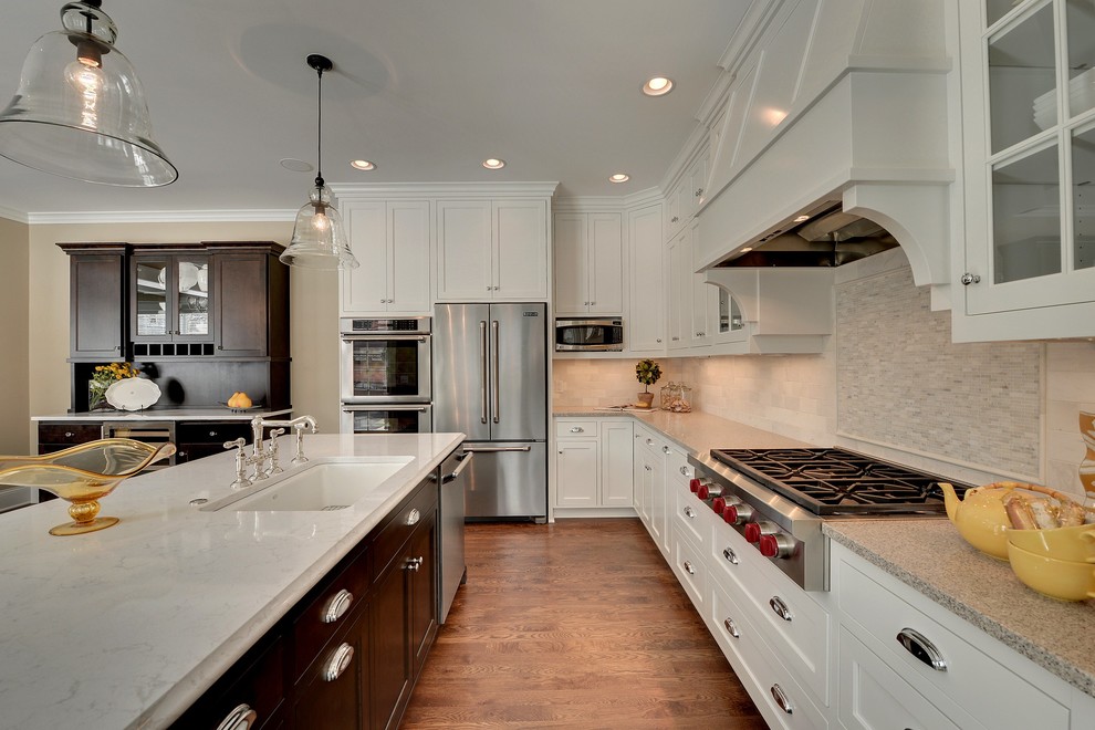Photo of a traditional kitchen in Minneapolis with stainless steel appliances and stone tile splashback.