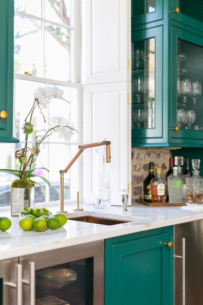 Design ideas for a mid-sized transitional home bar in Charleston with beaded inset cabinets, green cabinets, quartz benchtops, brown splashback, brick splashback, medium hardwood floors, brown floor and white benchtop.