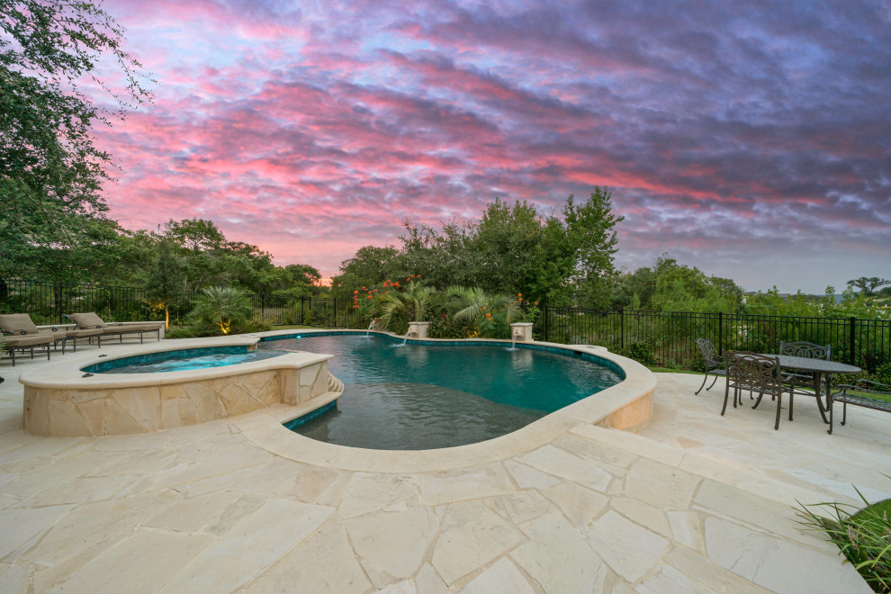 Inspiration for a large traditional backyard custom-shaped natural pool in Other with decking.