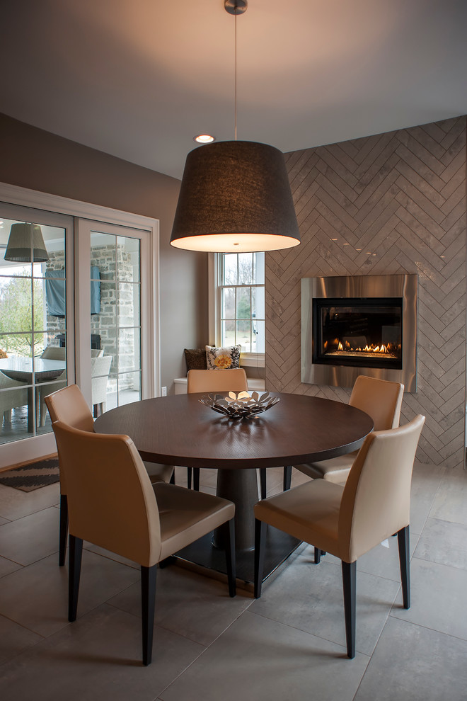 Inspiration for a contemporary dining room in Cincinnati with grey walls, a tile fireplace surround and ceramic floors.