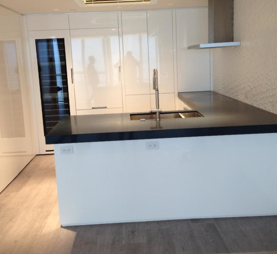 Mid-sized transitional u-shaped porcelain tile kitchen photo in Miami with an undermount sink, flat-panel cabinets, white cabinets, white backsplash, stainless steel appliances and a peninsula