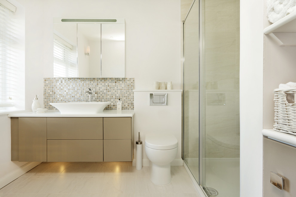 Design ideas for a contemporary bathroom in Hertfordshire with flat-panel cabinets, brown cabinets, an alcove shower, a one-piece toilet, beige tile, brown tile, gray tile, mosaic tile, white walls and a vessel sink.