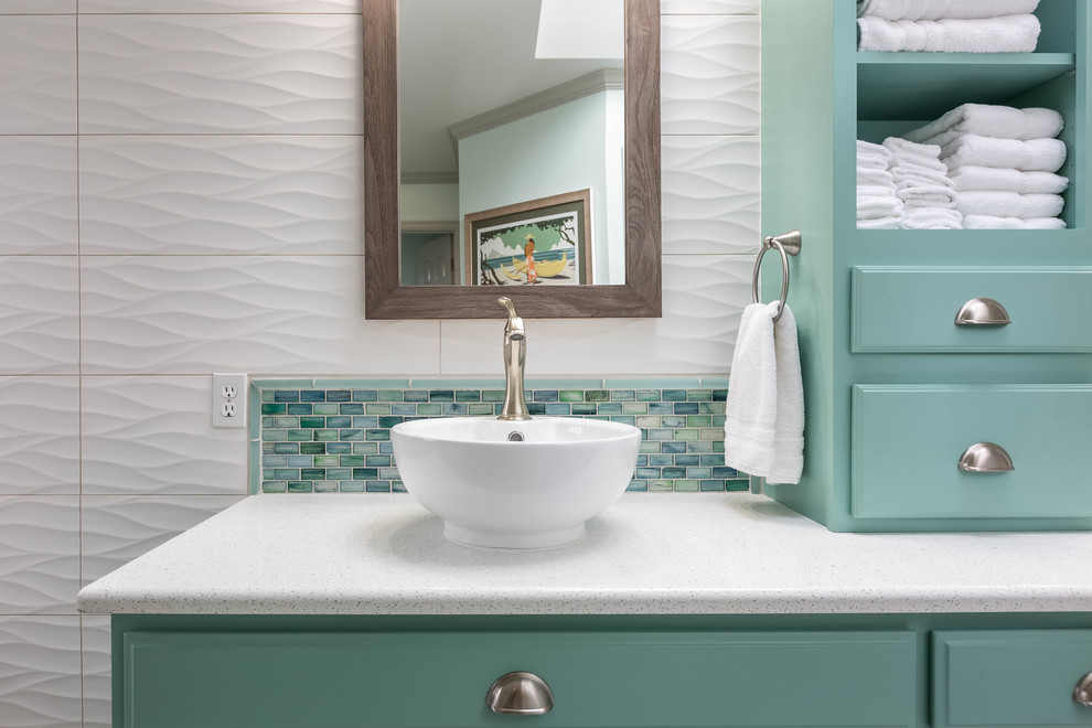 Inspiration for a large transitional master bathroom in Seattle with turquoise cabinets, a freestanding tub, white tile, glass tile, porcelain floors, a vessel sink, engineered quartz benchtops, grey floor, a hinged shower door, recessed-panel cabinets, a corner shower and white walls.
