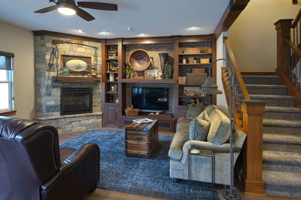 This is an example of a small transitional open concept family room in Omaha with beige walls, vinyl floors, a corner fireplace, a stone fireplace surround, a wall-mounted tv and brown floor.