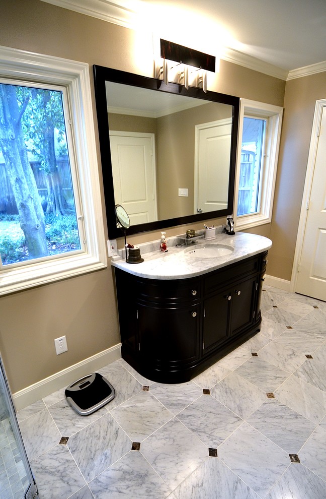 Photo of a mid-sized contemporary master bathroom in Houston with furniture-like cabinets, dark wood cabinets, a freestanding tub, a curbless shower, a two-piece toilet, gray tile, stone tile, green walls, marble floors, a vessel sink and quartzite benchtops.