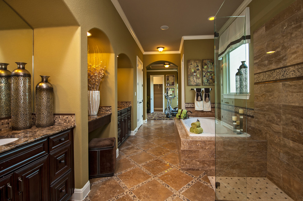 This is an example of a traditional bathroom in Austin with granite benchtops, brown floor, travertine and brown benchtops.