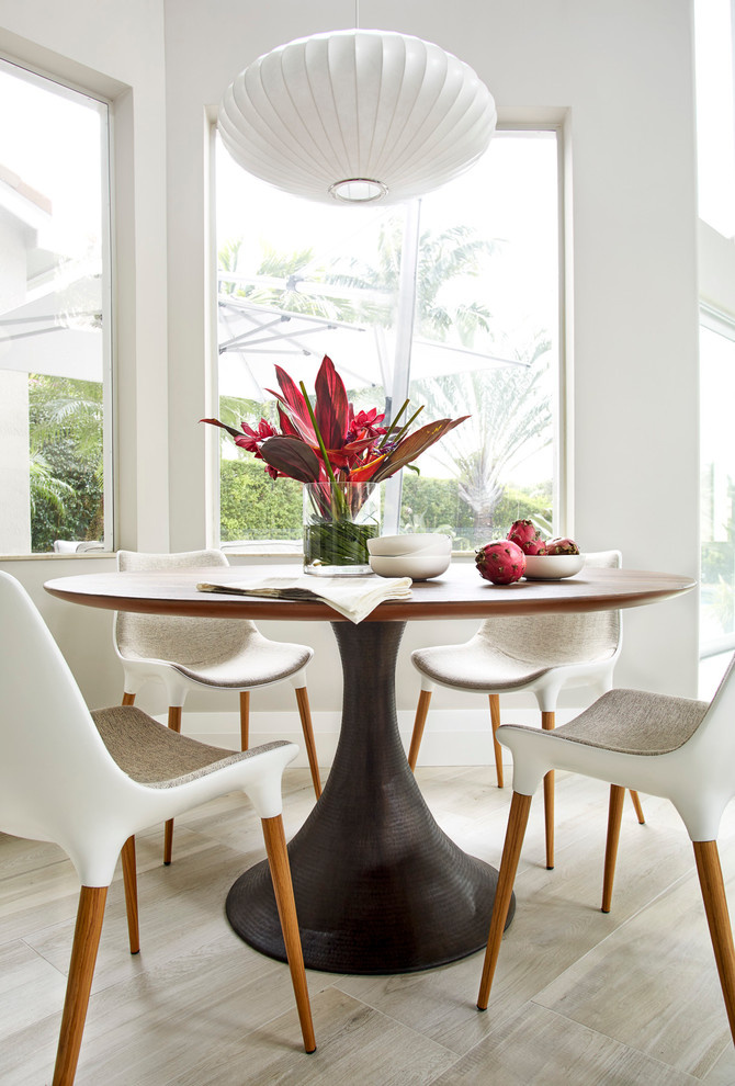 This is an example of a large contemporary dining room in Miami with white walls and porcelain floors.