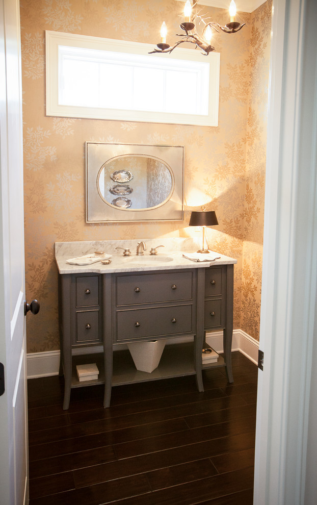 Inspiration for a mid-sized traditional powder room in Atlanta with flat-panel cabinets, grey cabinets, multi-coloured walls, dark hardwood floors, granite benchtops, brown floor and an undermount sink.