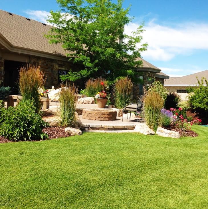 Inspiration for a large traditional backyard patio in Boise with a fire feature, natural stone pavers and a roof extension.
