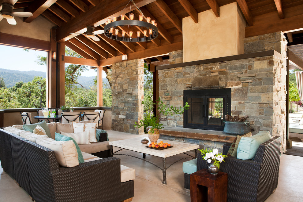 Large mediterranean backyard verandah in San Francisco with a fire feature and a roof extension.