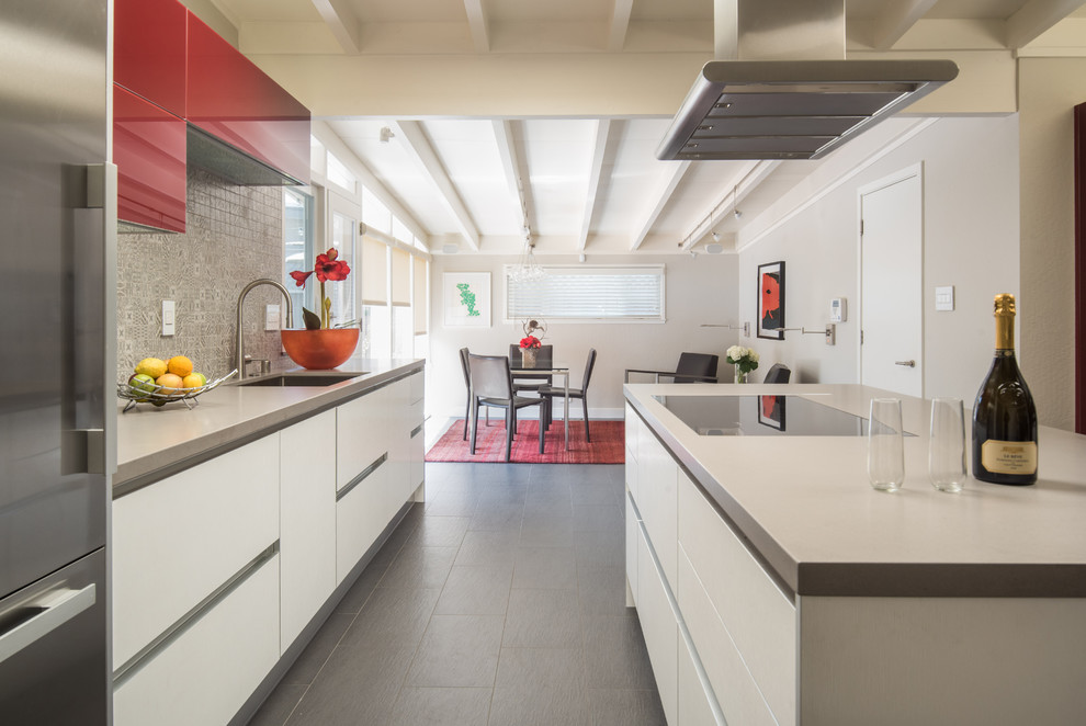 Photo of a mid-sized contemporary u-shaped eat-in kitchen in San Francisco with flat-panel cabinets, white cabinets, quartz benchtops, multi-coloured splashback, ceramic splashback, with island and grey benchtop.