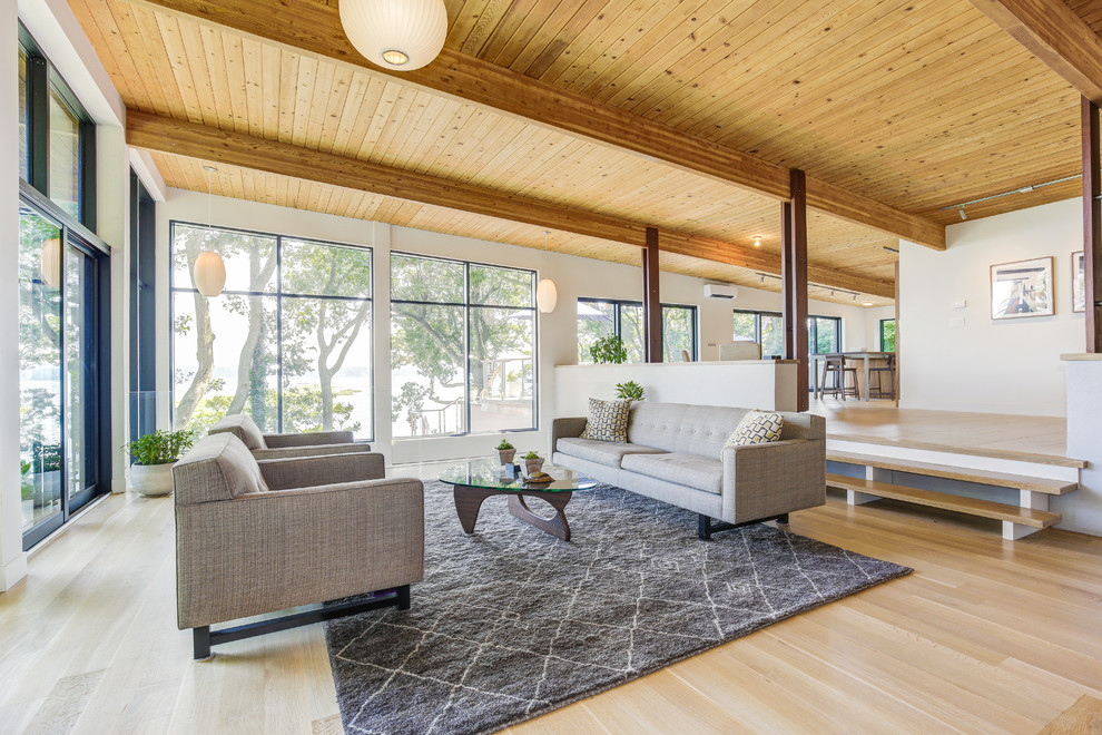 Example of a 1960s formal and open concept light wood floor and beige floor living room design in Seattle with white walls and no fireplace