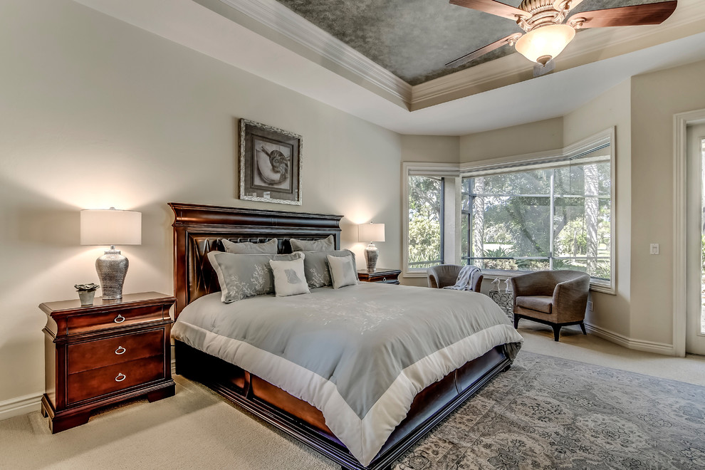 Inspiration for a traditional master bedroom in Miami with grey walls and carpet.