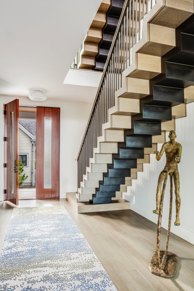 Inspiration for a large transitional wooden floating metal railing staircase remodel in Boston with metal risers