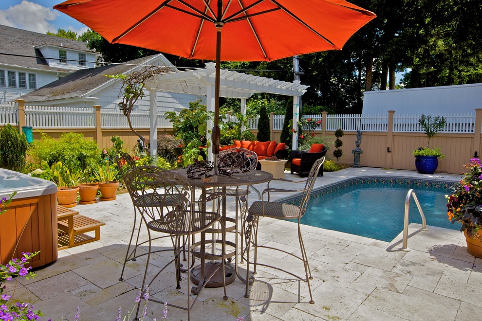 Inspiration for a small mediterranean backyard pool in New York with natural stone pavers.